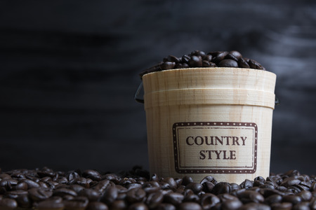 Coffee beans with casks on wood backgroundの写真素材