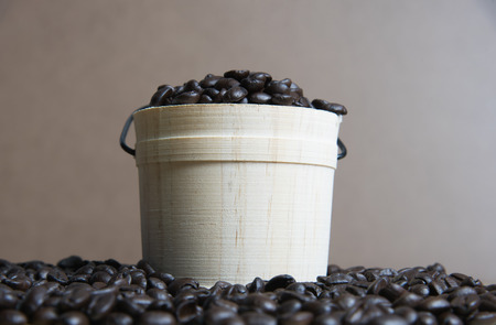 Coffee beans with casks on wood backgroundの写真素材