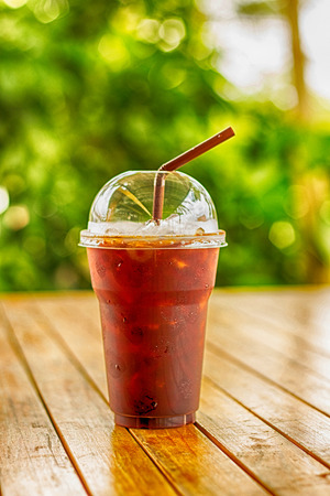 Iced Americano black coffee on a wooden tableの写真素材
