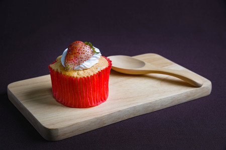 cup cake strawberry on brown backgroundの写真素材