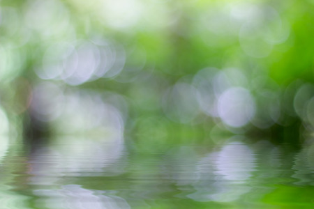 Natural background with rays of light, reflected in waterの写真素材
