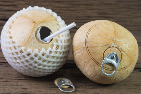 fresh coconut drink, coconut with pull ring on wooden tableの写真素材