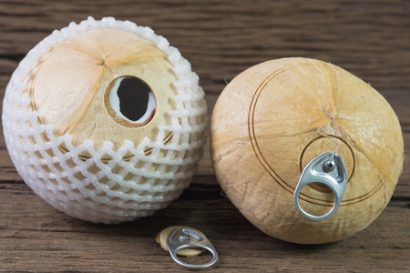 fresh coconut drink, coconut with pull ring on wooden tableの写真素材