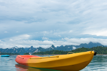 Kayak among mountains view, clear sky and clear waterの写真素材