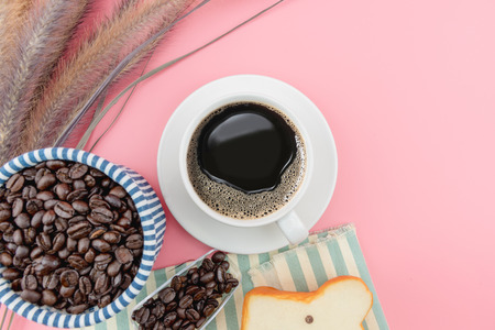 coffee concept flat lay top view Coffee cup and coffee beans with grass on pink background.の写真素材