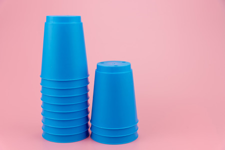 blue stacks plastic cups. Speed stack cup on pink backgroundの写真素材