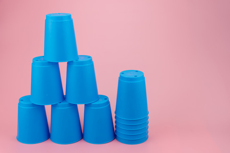 blue stacks plastic cups. Speed stack cup on pink backgroundの写真素材