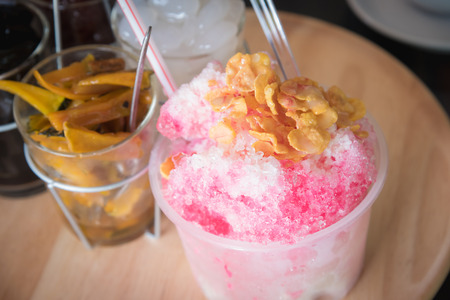 Shaved ice. Frozen Fruit Slush Drinks,Shaved Ice dessert on wood plate, Mix dessertの写真素材