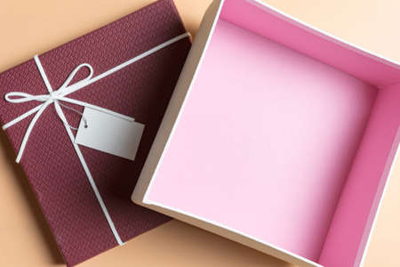 Red gift box, ribbon bundle on Cream yellow background