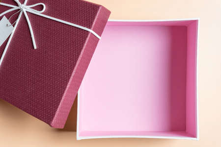 Red gift box, ribbon bundle on Cream yellow backgroundの写真素材