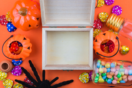 Halloween holiday background with pumpkin and candy. Halloween holiday concept top view. Pumpkins, spiders,  mask on orange backgroundの写真素材