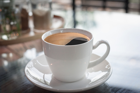 Hot art Latte Coffee in a cup on wooden table in Coffee shop の写真素材