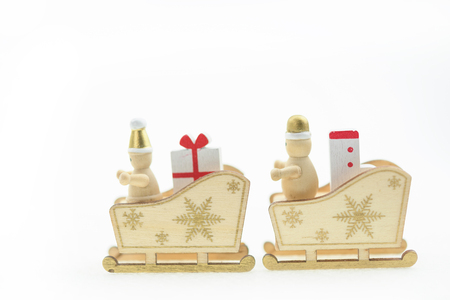  Santa Claus in a sleigh with gift and sock, all in woodの写真素材