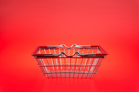 A Shopping Cart On red background, isolated shopping cart on the redの写真素材