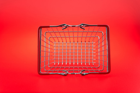 A Shopping Cart On red background, isolated shopping cart on the redの写真素材