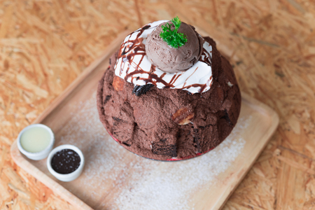 Korean Dessert - Chocolate bingsu or ice snow flake with fresh milk in korea style on wood tableの写真素材