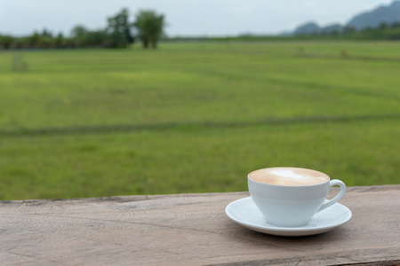 Coffee cup. A cup of coffee in a white cup on wooden backgroundの写真素材