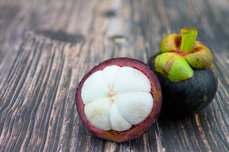 Mangosteen  fruit / Fresh mangosteen from garden Thailand , Queen of fruit. Garcinia mangostana. Fresh ripe mangosteen fruits on wooden tableの写真素材