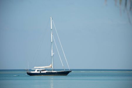 yacht in sea sky. Yacht sitting in crystal clear waters off the coast of Phuket, Thailand