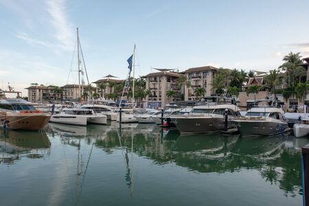 Yachts parking in harbor. Yacht harbor in blue sunset light, luxury summer cruise, leisure time, active life, Beautiful modern yachts in harborの写真素材