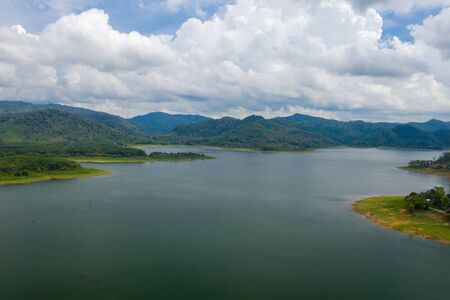 Dam Lake is located in Southern Thailand, lake serene with beautiful mountain background, Beautiful scenery of dam with mountain and lake view at Thailand, Asia.の写真素材