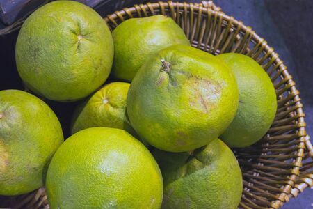 Green-yellow ripe pomelo, grapefruit, shaddock fruits from Thai farmer, Thailand market.