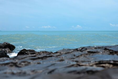 Wave crashing on the rocky reef. the waves of the ocean are breaking against the rocks. splashing ocean waves at sunset.の写真素材