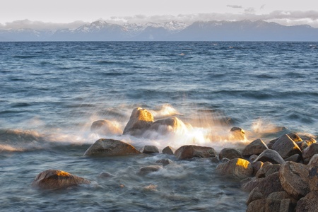 Water splash on rock with mountain in the background at Lake Tahoe, California, USAの写真素材