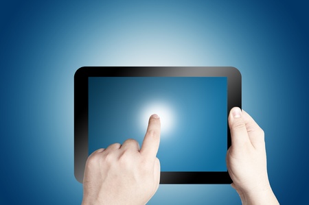 Hand holding and pointing on touch screen digital tabletの写真素材