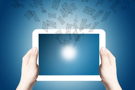 Hands holding and point on digital tablet with 3D mail icon flying out of touch screenの写真素材