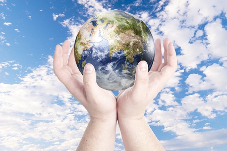 Man s hands holding on globe on cloudy blue sky  Concept for environmental protection from global warming  Data source  Nasaの写真素材