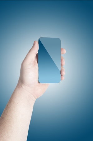 Man s hand holding on the touch screen mobile phone on blue backgroundの写真素材