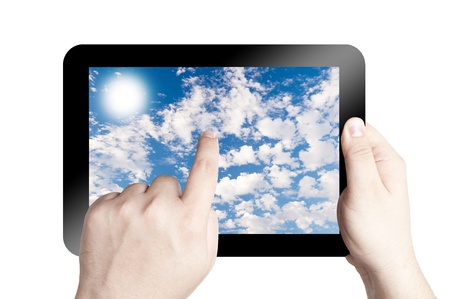 Hands holding and point on digital tablet with Cloudy sky background isolated on white backgroundの写真素材