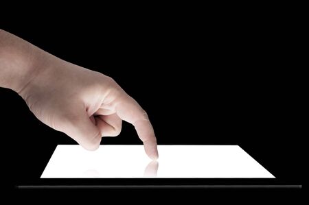 Businessman touch tablet PC screen isolated on blackの写真素材
