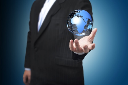 Business man with the digital globe ball floating on his hand  Concept for connectivity, communication within grasp  の写真素材