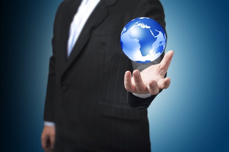 Business man with the digital globe ball floating on his hand  Concept for connectivity, communication within grasp  の写真素材