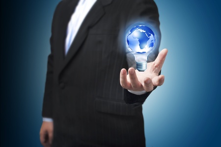 Business man with the digital globe ball inside light bulb floating on his hand  Concept for connectivity, communication within grasp  の写真素材