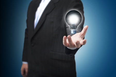 Business man with the light bulb floating on his hand  Concept for new Ideaの写真素材