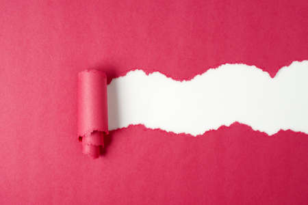 Torn red color paper on white backgroundの写真素材
