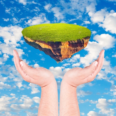 Piece of land in human hand against blue sky  Environmental protection concept の写真素材