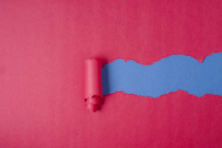 Red Tear Paper on blue backgroundの写真素材