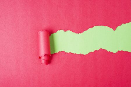 Red Tear Paper on green backgroundの写真素材