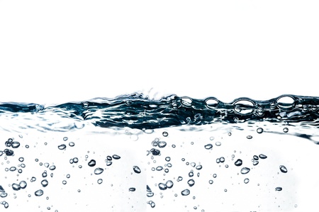 Air bubbles in ocean water rise to the surfaceの写真素材