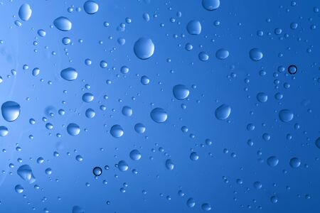 Water drop on blue backgroundの写真素材
