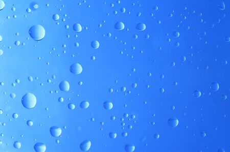 Water drop on blue backgroundの写真素材