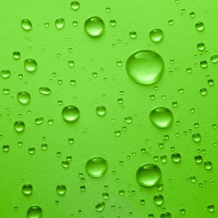 Water drop on green backgroundの写真素材