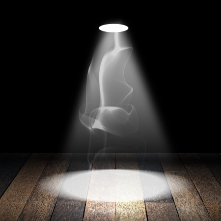 Spotlight with smoke on wood floorの写真素材