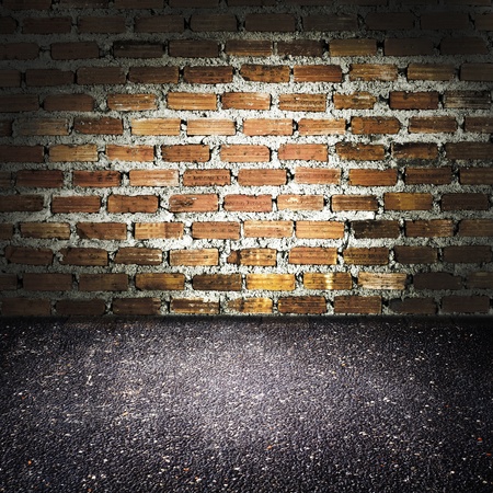 asphalt floor with brick wallの写真素材