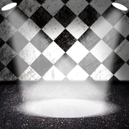 Spotlights on asphalt floor with checker wall in the backgroundの写真素材