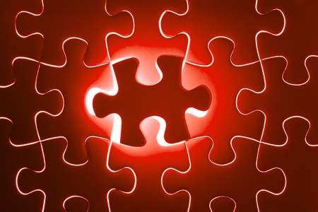 Missing Jigsaw puzzle in red color jigsaw  Business concept for completing team with key personの写真素材